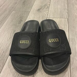 Black Gucci slides for men. Size 11. Barely worn.